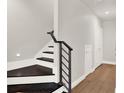 Modern staircase with dark wood treads and metal railing at 137 S Park Ave, Winter Garden, FL 34787