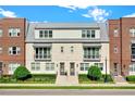 Two-story townhome with brick facade, metal roof, and landscaping at 137 S Park Ave, Winter Garden, FL 34787