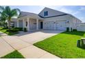 Two-story house with two-car garage and landscaping at 15162 Book Club Rd, Winter Garden, FL 34787