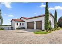 Three car garage with paver driveway and lake view at 7616 Lily Ct, Groveland, FL 34736