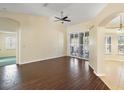 Spacious living area featuring dark brown tile floors and sliding glass doors at 114 Compass Rose Dr, Groveland, FL 34736