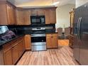 Kitchen with wood cabinets and stainless steel appliances at 2524 Good Homes Rd, Orlando, FL 32818