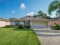 Single-story house with a well-manicured lawn at 533 Grand Vista Trl, Leesburg, FL 34748