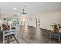 Spacious living room featuring wood-look floors and a ceiling fan at 533 Grand Vista Trl, Leesburg, FL 34748