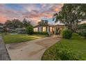 Inviting home exterior at dusk, showcasing curb appeal at 512 Palo Verde Dr, Leesburg, FL 34748
