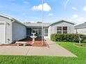 Front view of a single-Gathering home with a fountain and manicured lawn at 3330 Reston Dr, The Villages, FL 32162