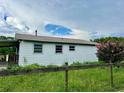 White ranch home with a large backyard and wooden fence at 708 Lake Shore Dr, Pierson, FL 32180