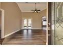 Bright living room with hardwood floors and french doors at 27303 Gingerbread Pl, Leesburg, FL 34748