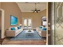 Living room with hardwood floors, sofas and rug at 27303 Gingerbread Pl, Leesburg, FL 34748