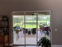 View of backyard patio and golf course through sliding glass doors at 9010 Laurel Ridge Dr, Mount Dora, FL 32757