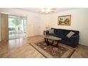 Living room with tile flooring, sliding doors to a screened porch, and comfortable seating at 3680 Doune Way, Clermont, FL 34711