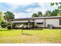 House exterior, side view, showing AC unit and lawn at 8042 County Road 109B, Lady Lake, FL 32159