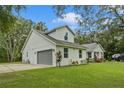 Single-story home with gray garage door and manicured lawn at 1136 Brick Rd, Winter Garden, FL 34787