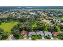Aerial view of a neighborhood with homes and green spaces at 3912 Plantation Blvd, Leesburg, FL 34748