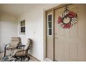 Inviting front porch with two chairs and a wreath on the door at 1012 Diego Ct, The Villages, FL 32159