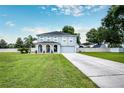 Two-story house with a large front yard, driveway, and attached garage at 7425 Lake Marni Ct, Mount Dora, FL 32757
