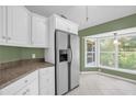 Spacious kitchen with white cabinets, stainless steel appliances, and granite countertops at 1500 Cobble Ln, Mount Dora, FL 32757