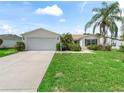 Single-story house with attached garage and manicured lawn at 3324 Reston Dr, The Villages, FL 32162