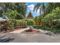 Landscaped walkway leading to an A-frame home at 507 Lakeshore Dr, Eustis, FL 32726