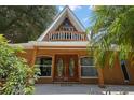 A-frame home with wood siding and a balcony at 507 Lakeshore Dr, Eustis, FL 32726