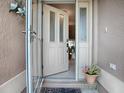 Open front door reveals interior with glass accents at 616 Cokesbury Dr, The Villages, FL 32162