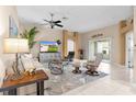 Living room with a sofa, armchairs, and a large TV at 3401 Fairfield St, The Villages, FL 32162
