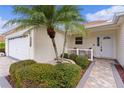 Front entrance of a single-story home with a paved walkway and landscaping at 3401 Fairfield St, The Villages, FL 32162