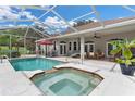 Relaxing pool and spa with screened enclosure at 5515 Citation Ct, Lady Lake, FL 32159