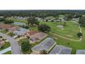 Aerial view of homes and golf course community at 32915 Crooked Oaks Ln, Leesburg, FL 34748
