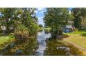 Peaceful waterfront view with a canal leading to a larger lake at 10367 Se Sunset Harbor Rd, Summerfield, FL 34491