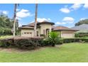 House exterior with a landscaped yard and two palm trees at 39644 Harbor Hills Blvd, Lady Lake, FL 32159