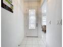 Bright entryway with tile flooring and glass-paned door at 4706 Glen Coe St, Leesburg, FL 34748