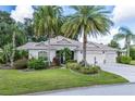 Attractive one-story house with a three-car garage and manicured lawn at 946 Adams Ln, The Villages, FL 32162