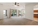 Spacious living room with sliding glass doors and neutral carpeting at 3431 Mount Hope Loop, Leesburg, FL 34748