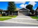 Single-story home with two-car garage and curb appeal at 4795 Ne 125Th Loop, Oxford, FL 34484