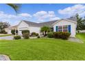 Single story home with landscaped yard, paver driveway, and two-car garage at 17913 Se 88Th Cascade Ct, The Villages, FL 32162