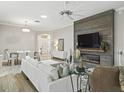 Living room featuring a fireplace and built-in media wall at 3162 Webster Way, The Villages, FL 32163