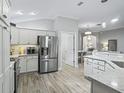 Modern kitchen with stainless steel appliances and white cabinets at 3162 Webster Way, The Villages, FL 32163
