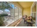 Cozy screened porch with seating for relaxing outdoors at 1213 El Esparza Ln, The Villages, FL 32159