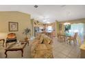 Open living and dining area with floral sofa and kitchen view at 1213 El Esparza Ln, The Villages, FL 32159