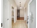 Bright entryway with tile flooring and laundry closet at 306 Bishopville Loop # 117, The Villages, FL 32162