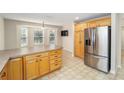 Kitchen with an island, stainless steel appliances, and ample cabinet space at 306 Bishopville Loop # 117, The Villages, FL 32162
