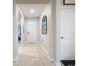 Bright and airy entryway with tile flooring and a mirror at 7833 June Ln, Wildwood, FL 34785