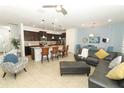 Open concept kitchen and living area with dark cabinetry and leather furniture at 2019 Majorca Dr, Kissimmee, FL 34747