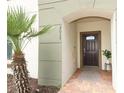 Inviting entryway to a townhome with a dark brown door and brick pathway at 2019 Majorca Dr, Kissimmee, FL 34747