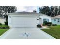 Single story home with a two-car garage and well manicured lawn at 16360 Sw 15Th Ct, Ocala, FL 34473