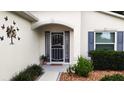 Inviting front entrance with a decorative wreath and updated door at 16360 Sw 15Th Ct, Ocala, FL 34473