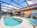 Inviting pool area with a screened enclosure and comfortable lounge chairs at 426 Orange Cosmos Blvd, Davenport, FL 33837