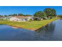 Backyard waterfront view of a single-Gathering home at 120 Trailwood Dr, Leesburg, FL 34748