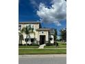 Two-story house with tan siding, stone accents, and a walkway at 2157 Valencia Blossom St, Clermont, FL 34711